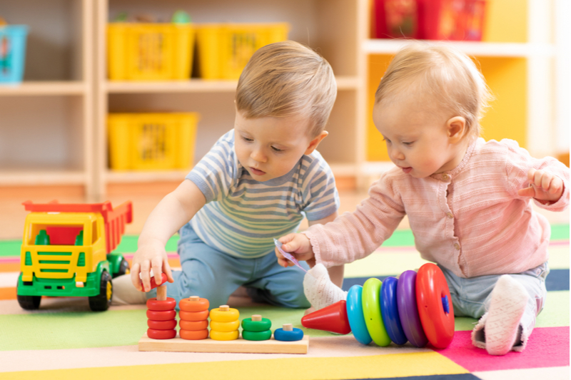 two babies playing in childcare nursery